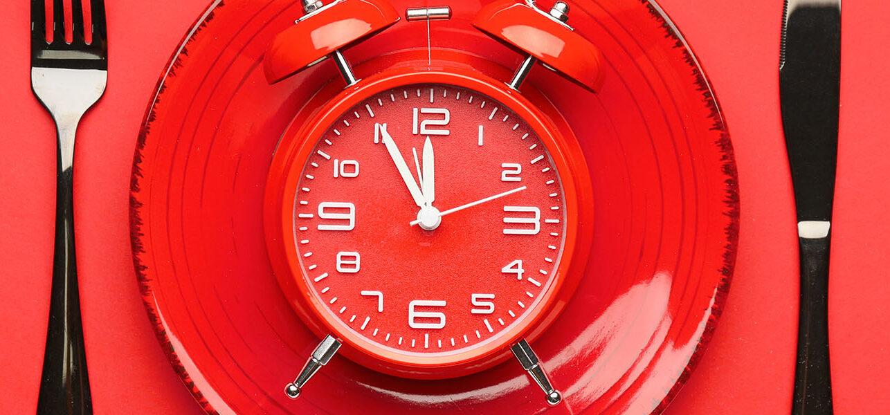 Red clock on red plate