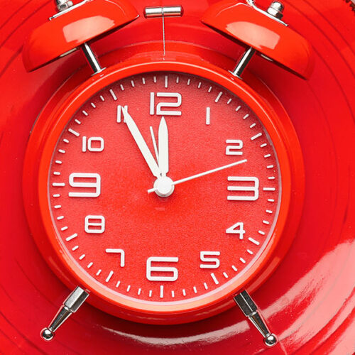 Red clock on red plate