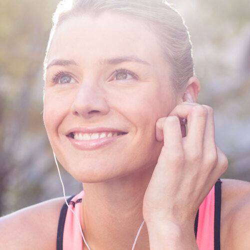 Smiling woman with earphones