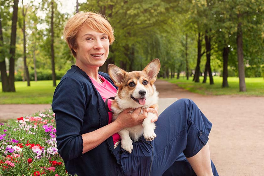 Middle aged woman holding a dog