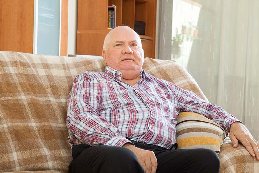 Obsessed man sitting in armchair