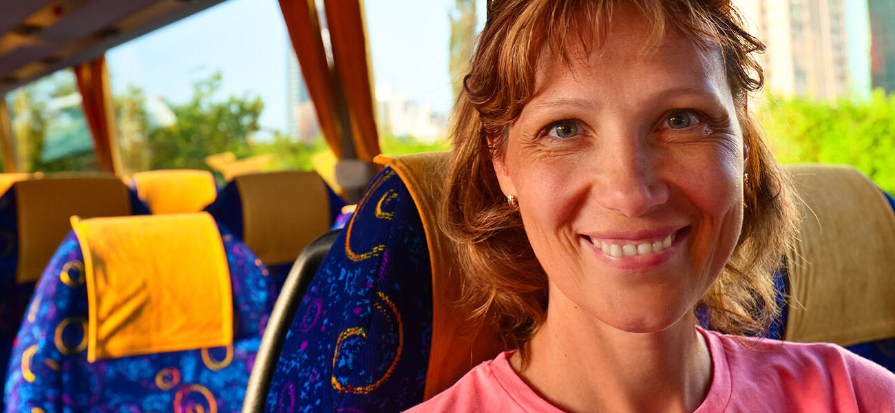 Smiling middle aged woman in the bus