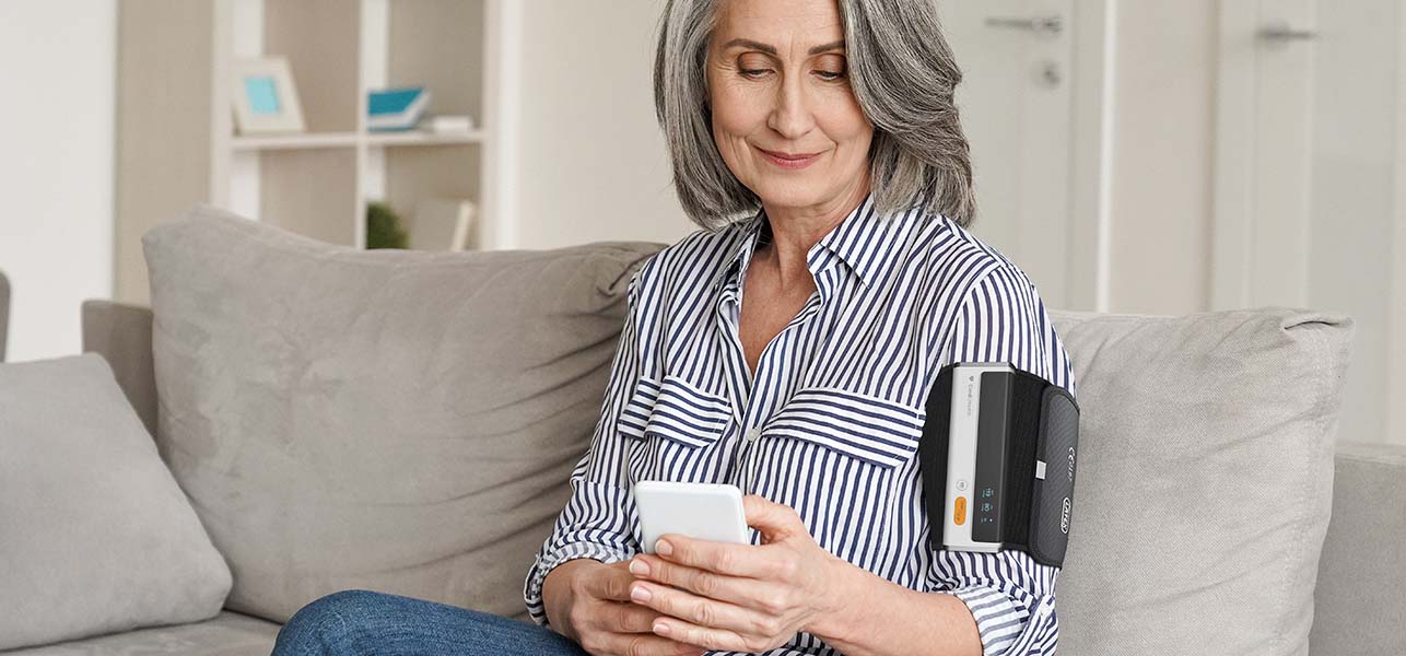 Elder gray haired woman using a smartphone