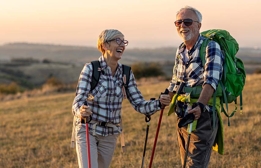 Laughing older couple in hiking outfit