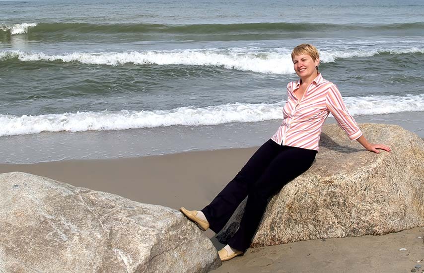 Middle aged woman posing at the beach