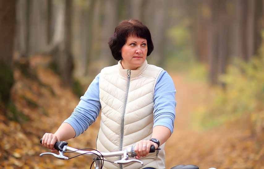 Dark haired woman on a bicycle