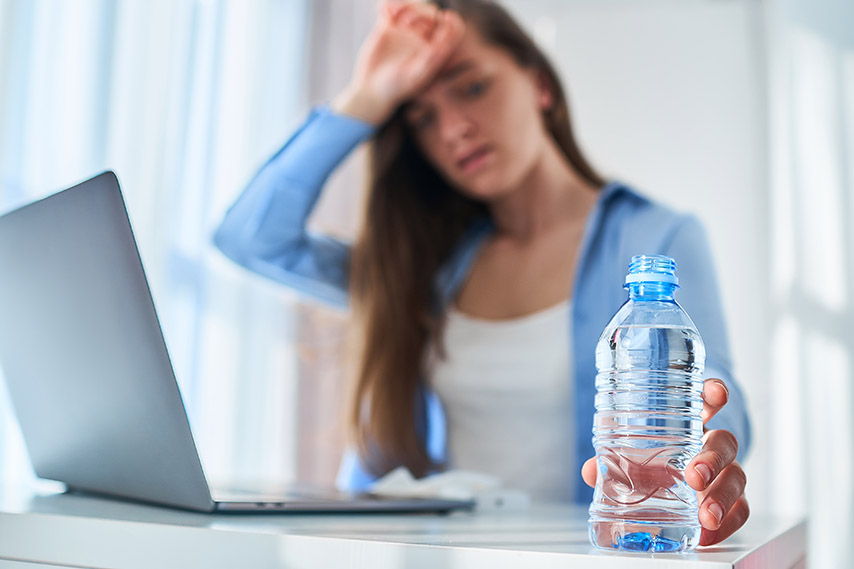 woman not feeling well and holdinng water
