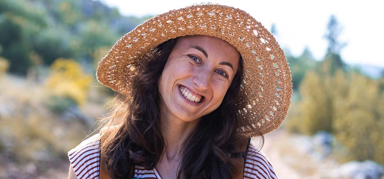 Smiling middle aged woman in straw hat