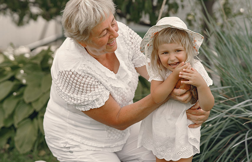Older woman holding a smiling child