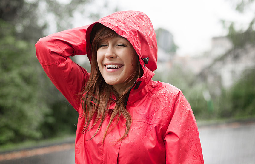 Laughing woman in red raincoat