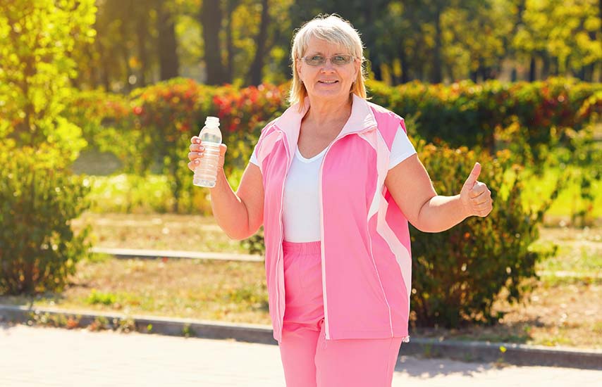 Older aged woman in pink tracksuit