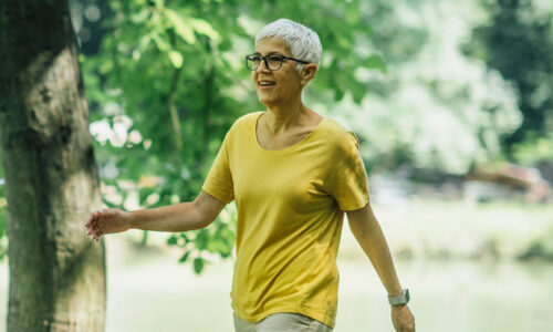 Older woman in yellow shirt having a walk