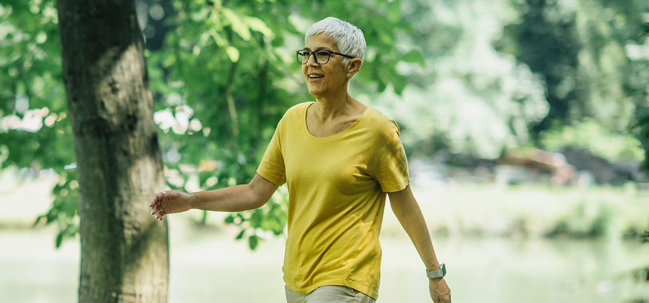 Older woman in yellow shirt having a walk
