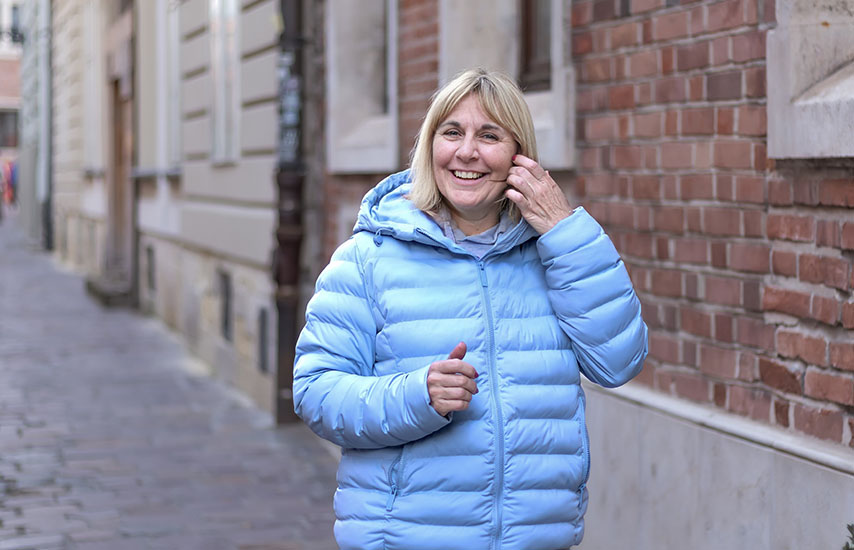 Smiling middle aged woman in sky blue jacket